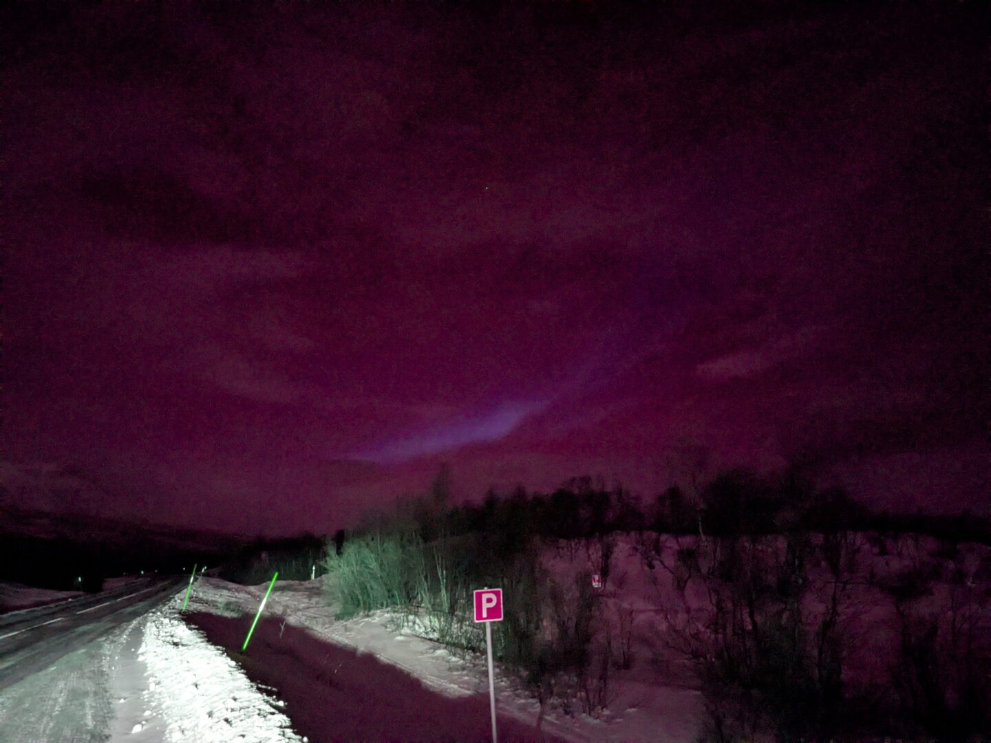 Roadside pull-off with slight aurora ahead.